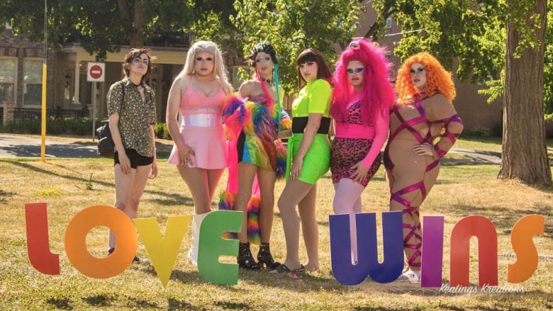 Drag performers pose with the 'love wins' sign at last year's Wortley Pride event in London, Ont.