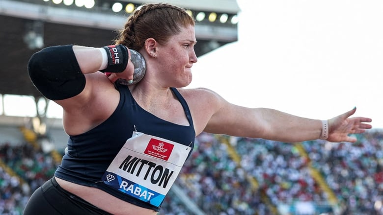 Female athlete competes in shot put at Diamond League track and field meet.